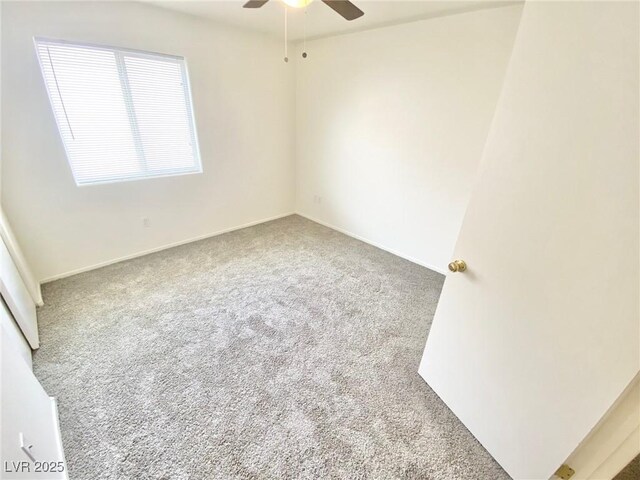 spare room featuring carpet flooring, baseboards, and ceiling fan