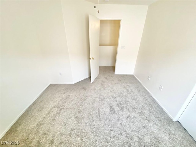 unfurnished bedroom featuring carpet and baseboards