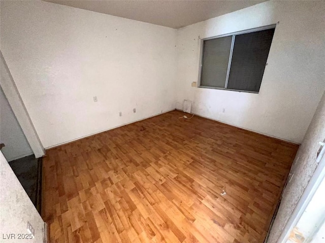 spare room featuring wood finished floors