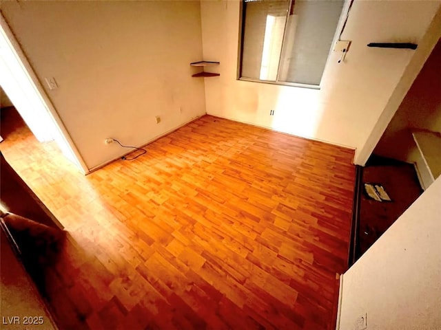 spare room featuring wood finished floors