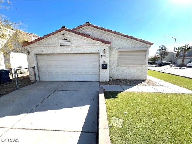 view of front of property featuring stucco siding, driveway, fence, a garage, and a tiled roof