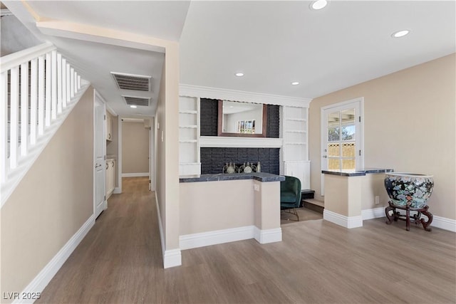 hall featuring stairway, recessed lighting, wood finished floors, and visible vents