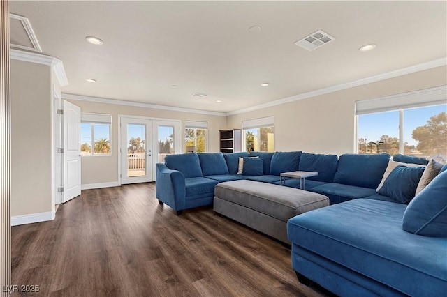 living area featuring dark wood-style floors, plenty of natural light, french doors, and visible vents