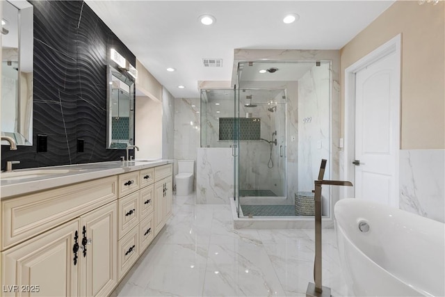 bathroom featuring a marble finish shower, double vanity, recessed lighting, a sink, and marble finish floor