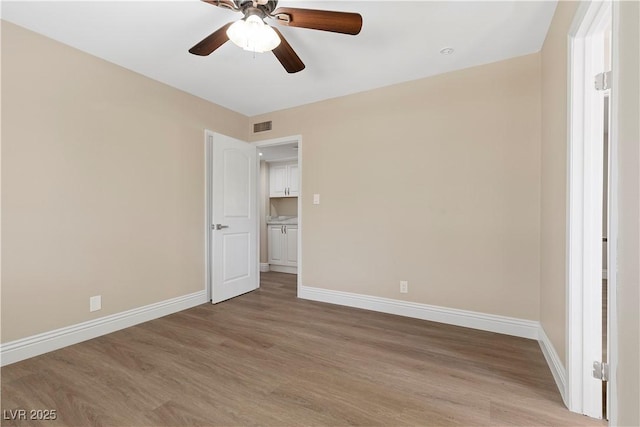 unfurnished bedroom with visible vents, ceiling fan, light wood-type flooring, and baseboards