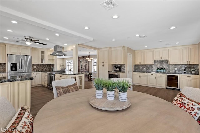 dining area with wine cooler, visible vents, dark wood finished floors, and recessed lighting