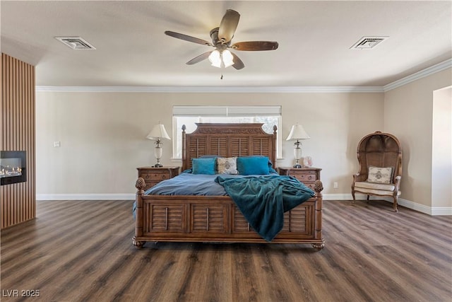 bedroom with visible vents, baseboards, and wood finished floors