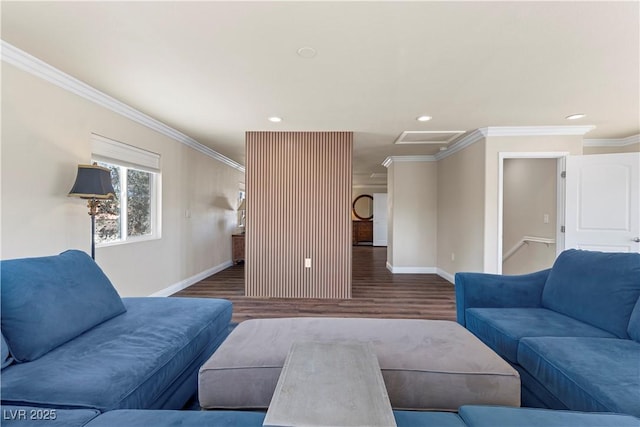 living room featuring baseboards, attic access, wood finished floors, and crown molding