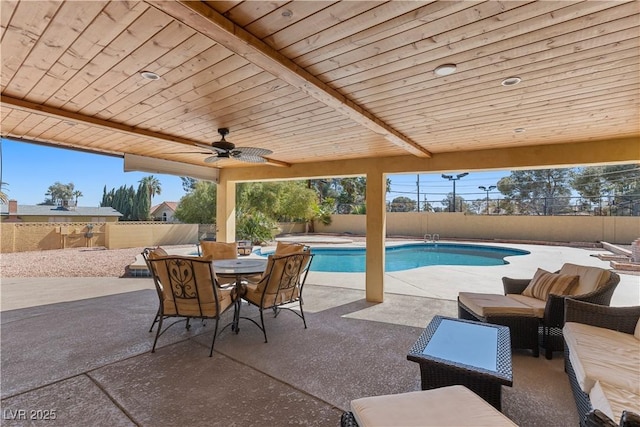 view of patio / terrace with an outdoor living space, a fenced in pool, outdoor dining area, a fenced backyard, and a ceiling fan