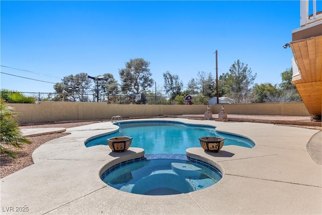 view of swimming pool with a patio area, a pool with connected hot tub, and a fenced backyard