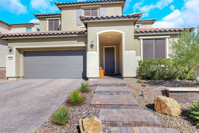 mediterranean / spanish-style house with decorative driveway and stucco siding