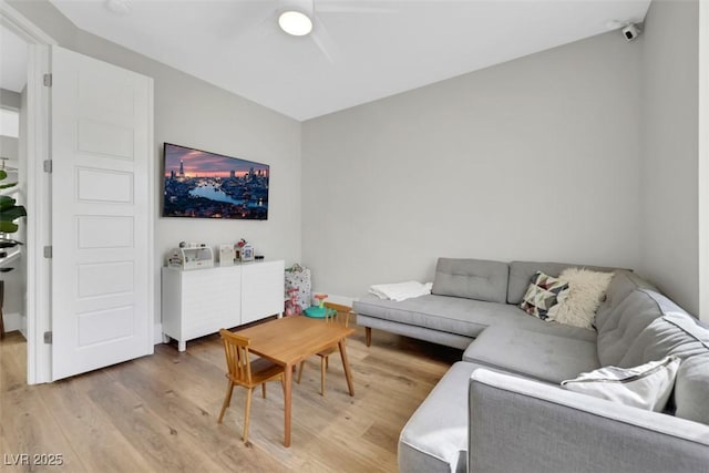 living room with light wood-style floors and ceiling fan