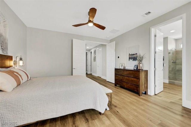 bedroom featuring visible vents, light wood-style flooring, ensuite bathroom, baseboards, and ceiling fan