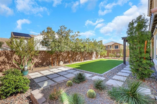 view of yard with a patio, a fenced backyard, and a pergola