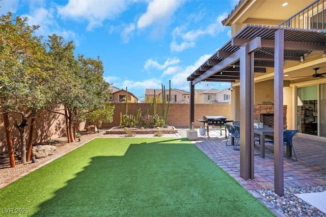 view of yard featuring ceiling fan, a patio area, a fenced backyard, and a pergola