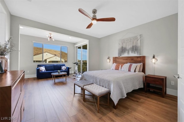 bedroom with access to outside, wood finished floors, baseboards, and ceiling fan