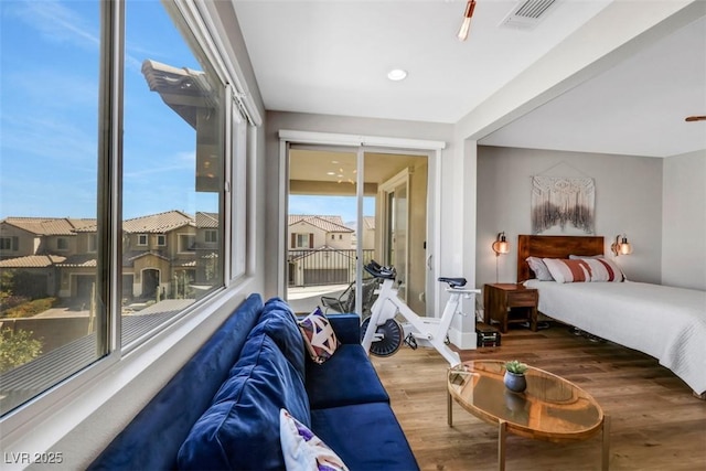 bedroom with visible vents and wood finished floors