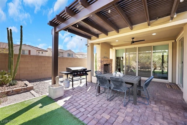 view of patio / terrace featuring fence, area for grilling, outdoor dining area, a pergola, and an outdoor stone fireplace