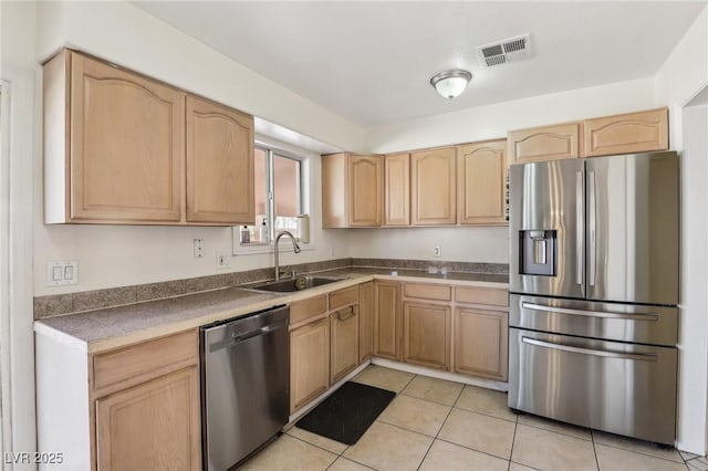 kitchen with visible vents, light brown cabinets, light tile patterned floors, appliances with stainless steel finishes, and a sink