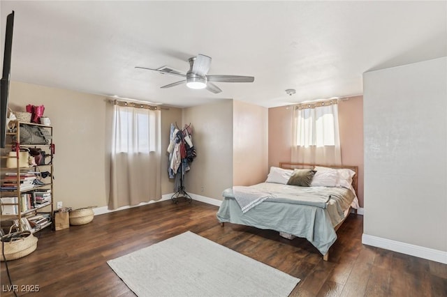 bedroom featuring a ceiling fan, wood finished floors, and baseboards