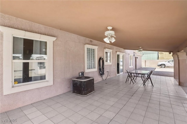 view of patio with cooling unit, outdoor dining area, and ceiling fan