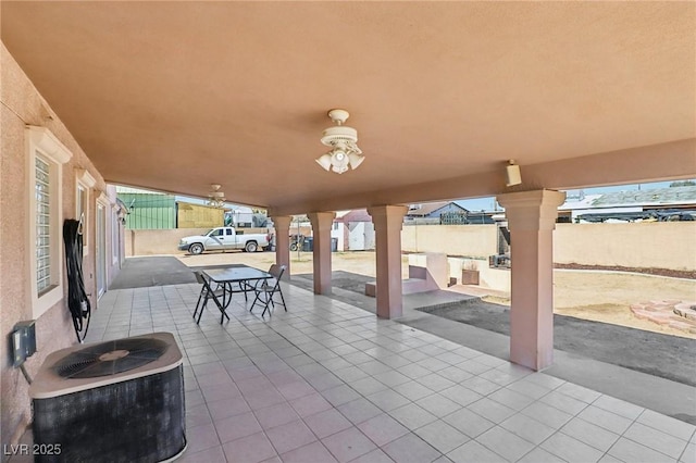 view of patio featuring an outdoor kitchen, cooling unit, and fence