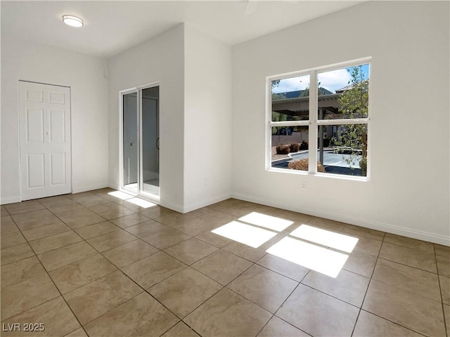 unfurnished bedroom featuring tile patterned floors and baseboards