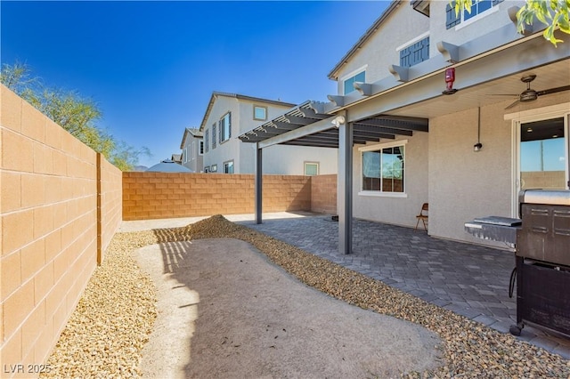 view of yard featuring a patio area, ceiling fan, a pergola, and a fenced backyard