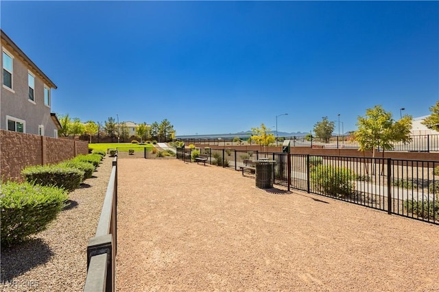 view of home's community featuring fence