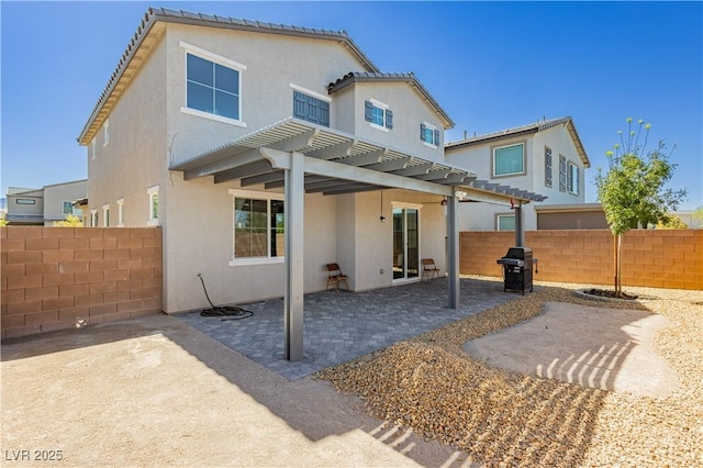 back of property featuring stucco siding, a pergola, a patio, and fence