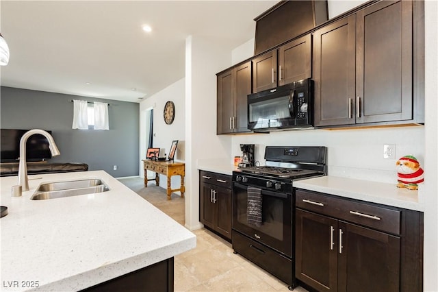 kitchen with black appliances, open floor plan, dark brown cabinetry, and a sink