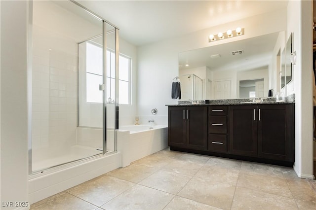 full bathroom featuring tile patterned flooring, visible vents, a shower stall, a garden tub, and double vanity