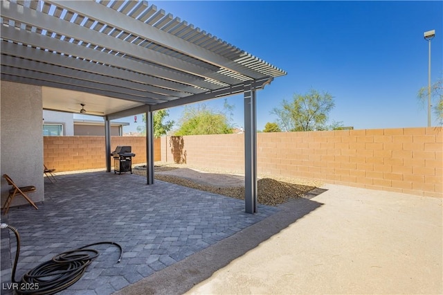 view of patio featuring grilling area, a pergola, and a fenced backyard