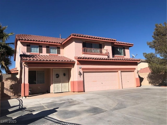 mediterranean / spanish house with stucco siding, concrete driveway, a garage, a balcony, and a tiled roof