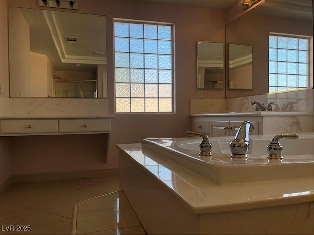 bathroom featuring tile patterned floors, visible vents, and a wealth of natural light