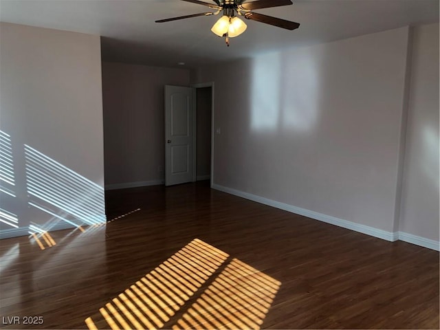 empty room with a ceiling fan, wood finished floors, and baseboards