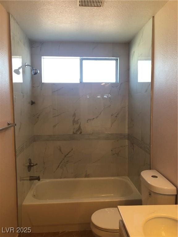 full bath with shower / bath combination, a healthy amount of sunlight, toilet, and vanity