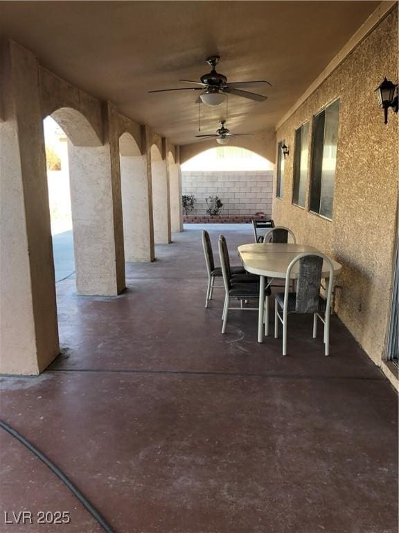 view of patio featuring outdoor dining space and a ceiling fan