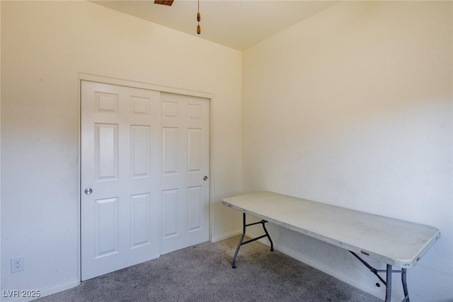 carpeted office featuring a ceiling fan and baseboards