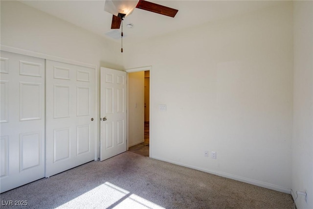 unfurnished bedroom with ceiling fan, carpet, a closet, and baseboards