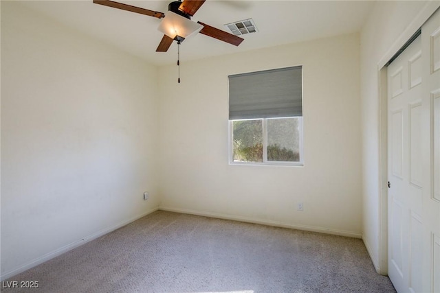 unfurnished bedroom with baseboards, visible vents, carpet floors, and ceiling fan