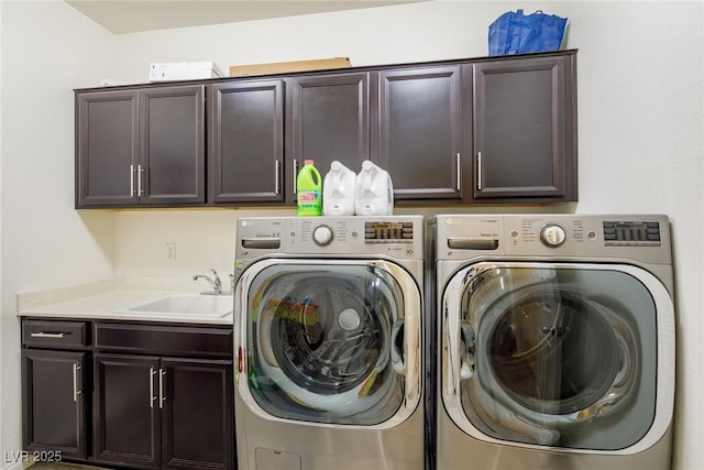 clothes washing area featuring cabinet space, independent washer and dryer, and a sink