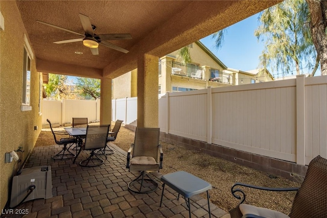 view of patio / terrace featuring outdoor dining space, a fenced backyard, and ceiling fan