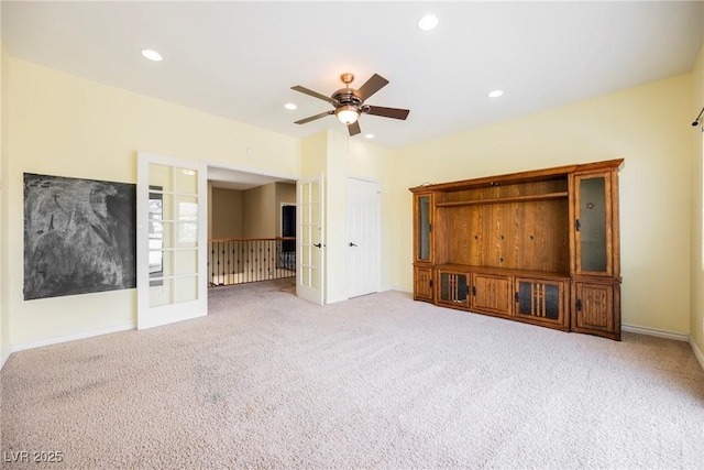 unfurnished living room featuring recessed lighting, french doors, and carpet