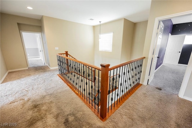 hall with an upstairs landing, recessed lighting, baseboards, and carpet