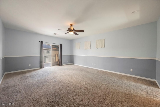 unfurnished room with visible vents, carpet flooring, a ceiling fan, and baseboards