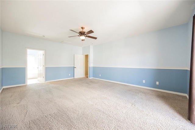 spare room featuring carpet, baseboards, and ceiling fan