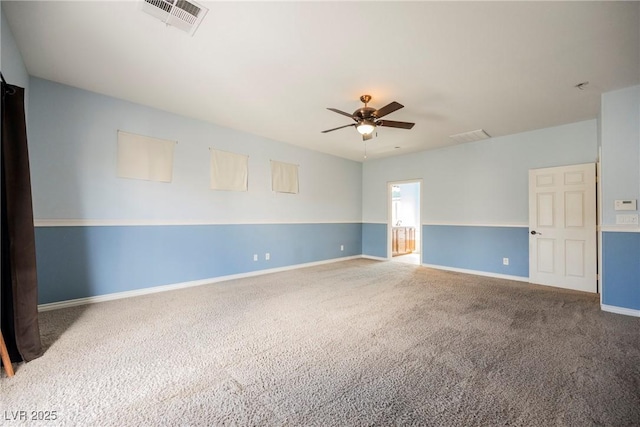 carpeted empty room featuring baseboards, visible vents, and ceiling fan