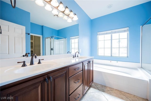 bathroom featuring double vanity, a stall shower, a bath, tile patterned floors, and a sink