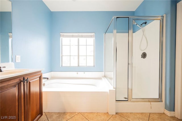 full bath featuring tile patterned floors, a shower stall, vanity, and a garden tub